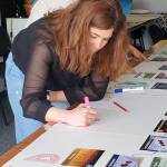 People working on a climate fresk during a learning workshop on climate change