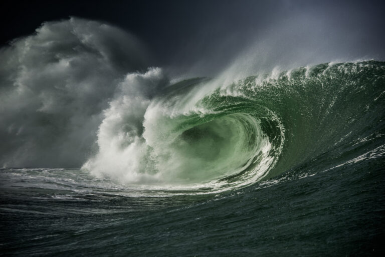 Big green wave breaking as it rolls to the left with lots of spray. Licensed from Shutterstock.